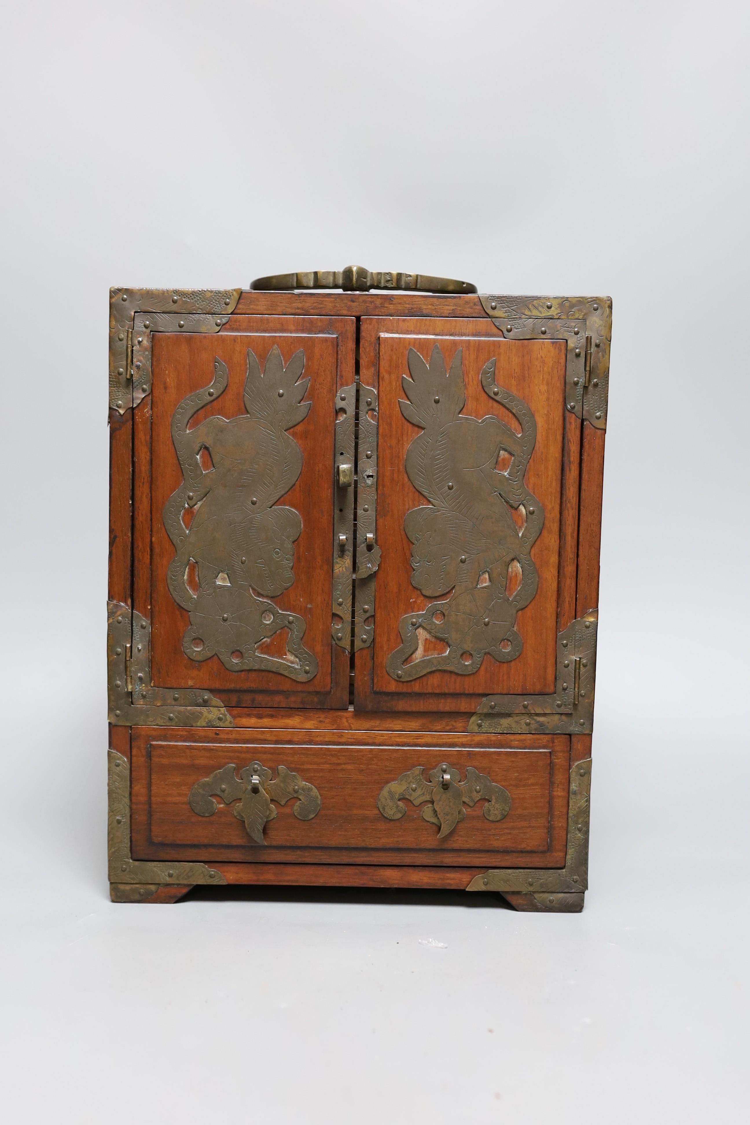A Chinese brass mounted two door, five drawer cabinet, 29 cms high